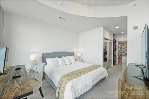 a bedroom with a bed and a couch