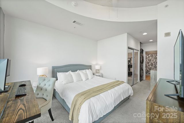 a bedroom with a bed and a couch