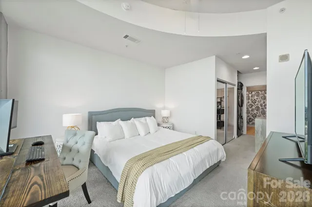 a bedroom with a large bed and a large window