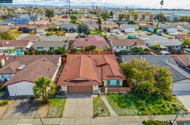 an aerial view of residential houses with outdoor space and swimming pool