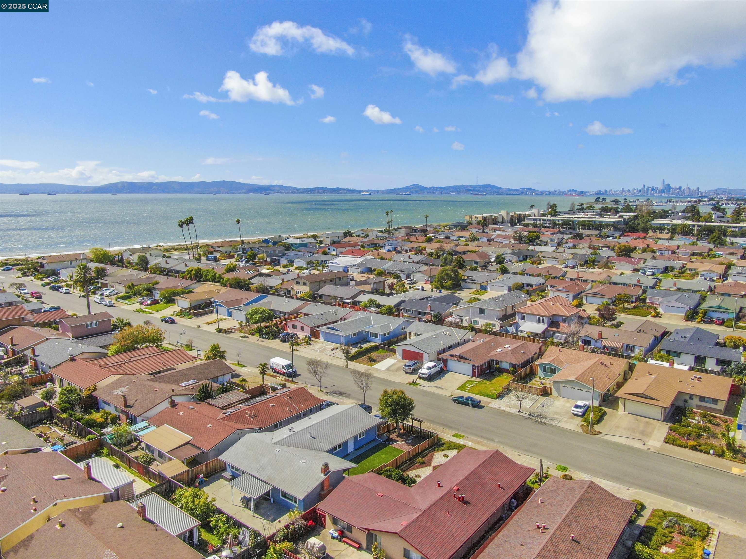 404 Coral Reef Road Alameda, CA 94501 - Photo 5 of 33 an aerial view of a city with lots of residential buildings and ocean view in back