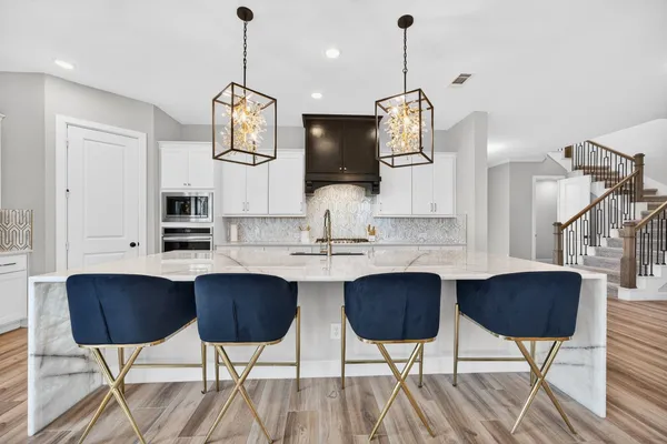 a kitchen with a sink appliances and a counter top space