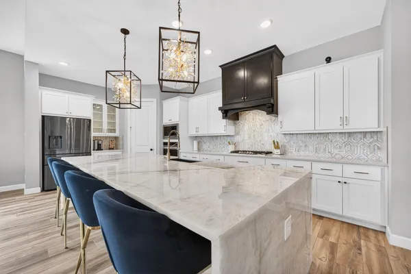 a kitchen with a stove and a white cabinet