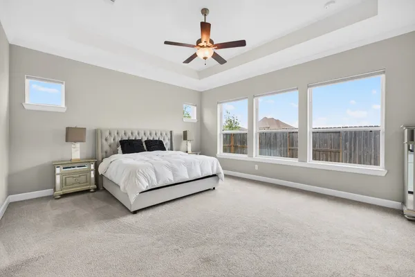 a bedroom with a bed and a large window
