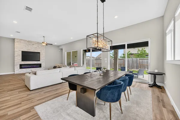 a living room with furniture a flat screen tv and kitchen view