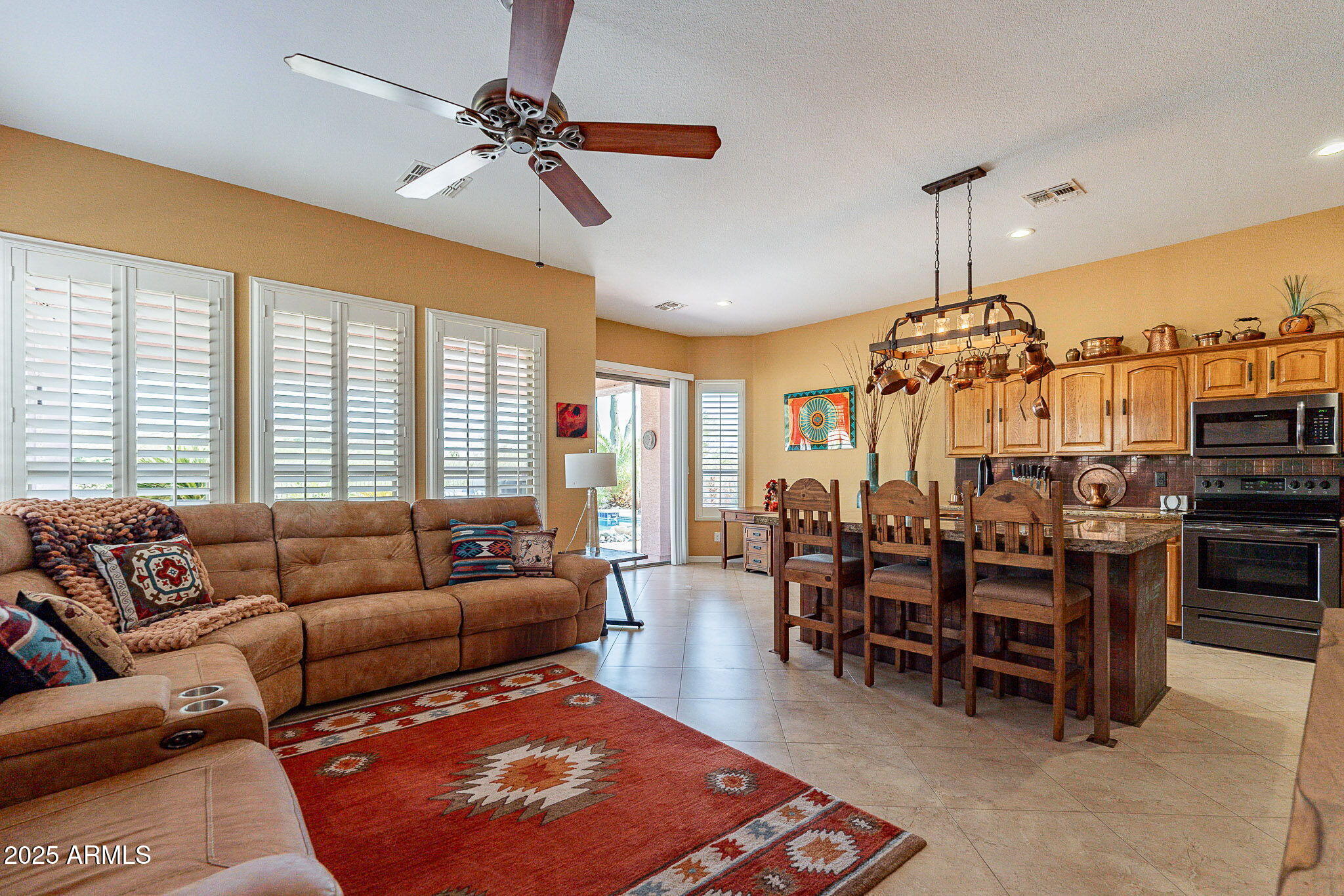 4333 South Pony Rider Trail Gold Canyon, AZ 85118 - Photo 16 of 54 a living room with furniture a chandelier and a dining table