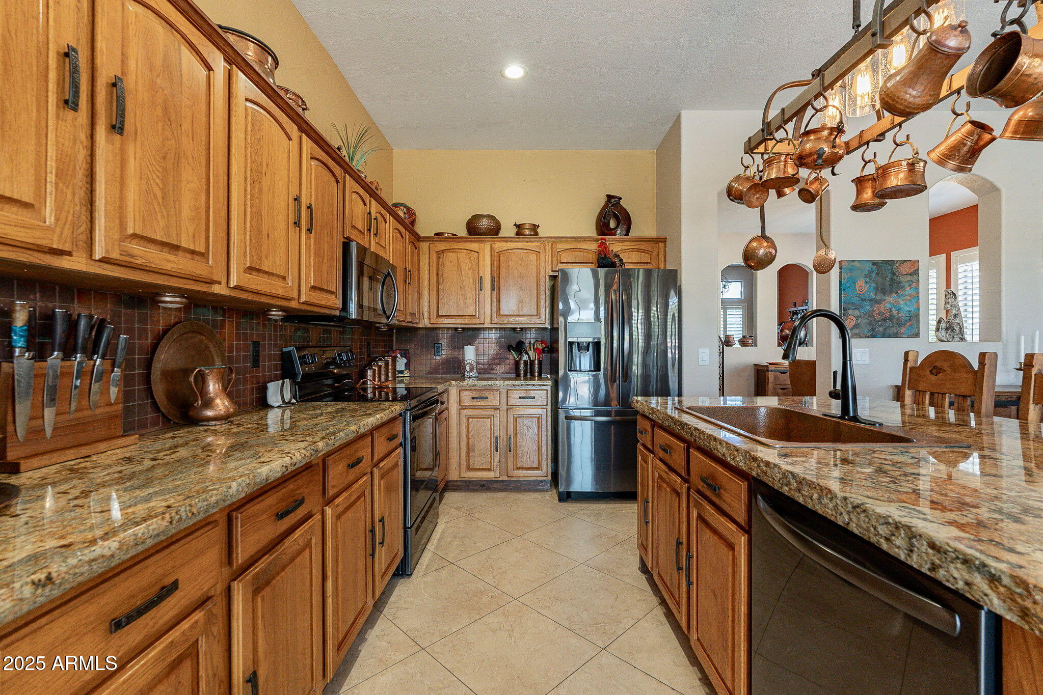 4333 South Pony Rider Trail Gold Canyon, AZ 85118 - Photo 20 of 54 a kitchen with stainless steel appliances granite countertop a sink a stove and a wooden cabinets