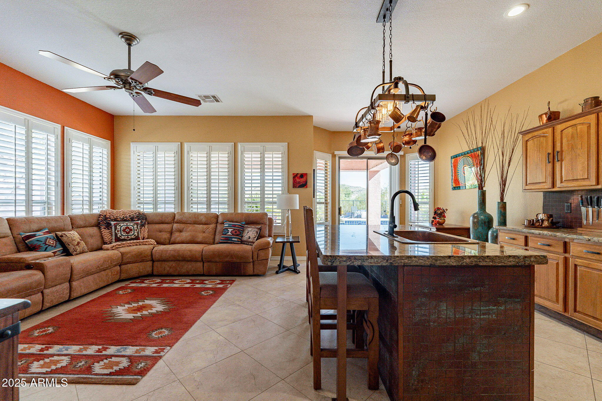 4333 South Pony Rider Trail Gold Canyon, AZ 85118 - Photo 3 of 54 a living room with furniture a chandelier and a flat screen tv