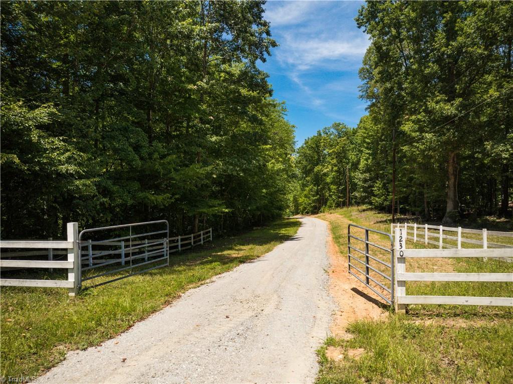 1230 Delta Acres Road Sandy Ridge, NC 27046 - Photo 3 of 46 Locked gated entrance