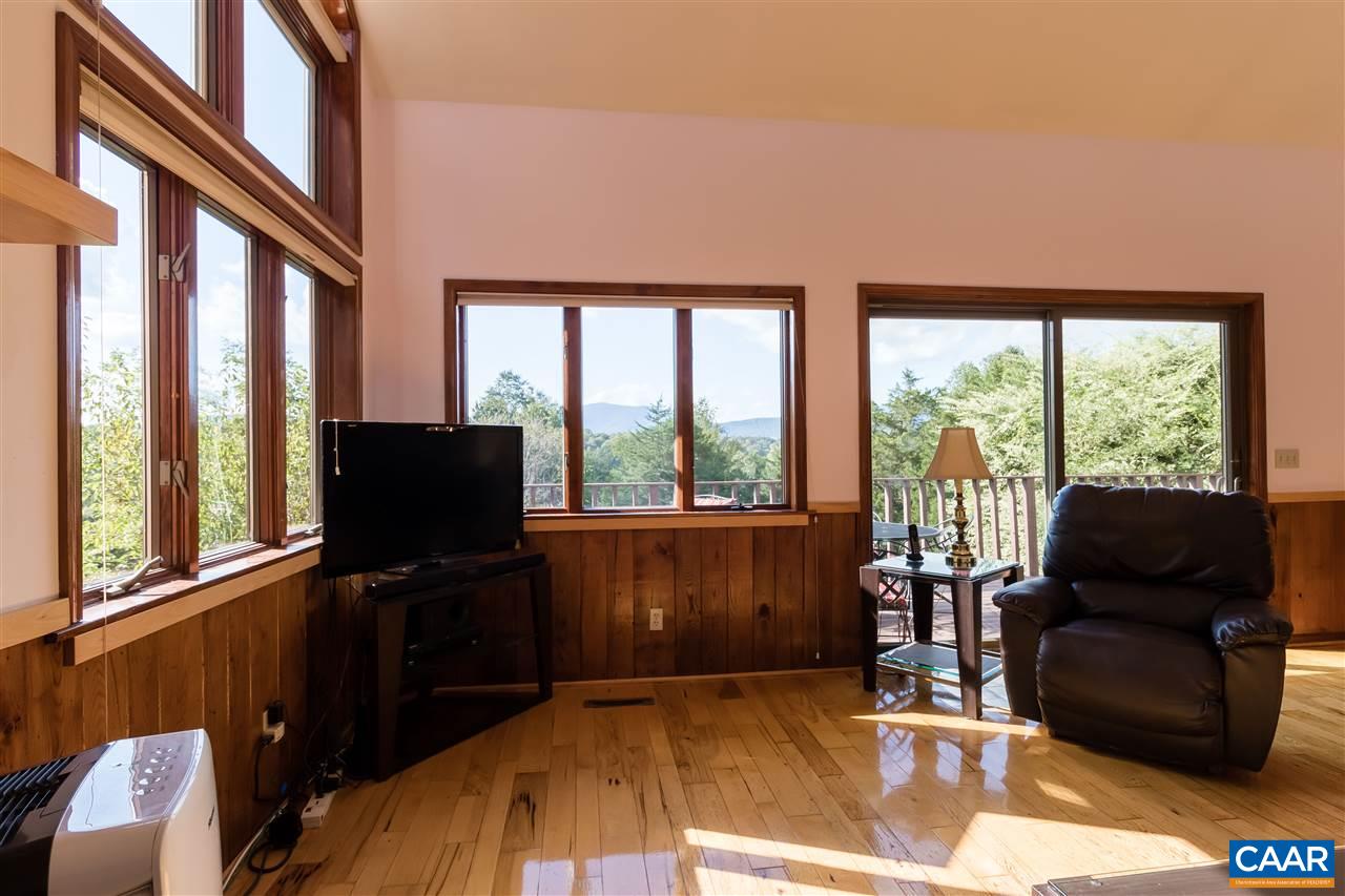 1655 Swift Run Road Ruckersville, VA 22968 - Photo 7 of 32 a living room with furniture tv and a floor to ceiling window