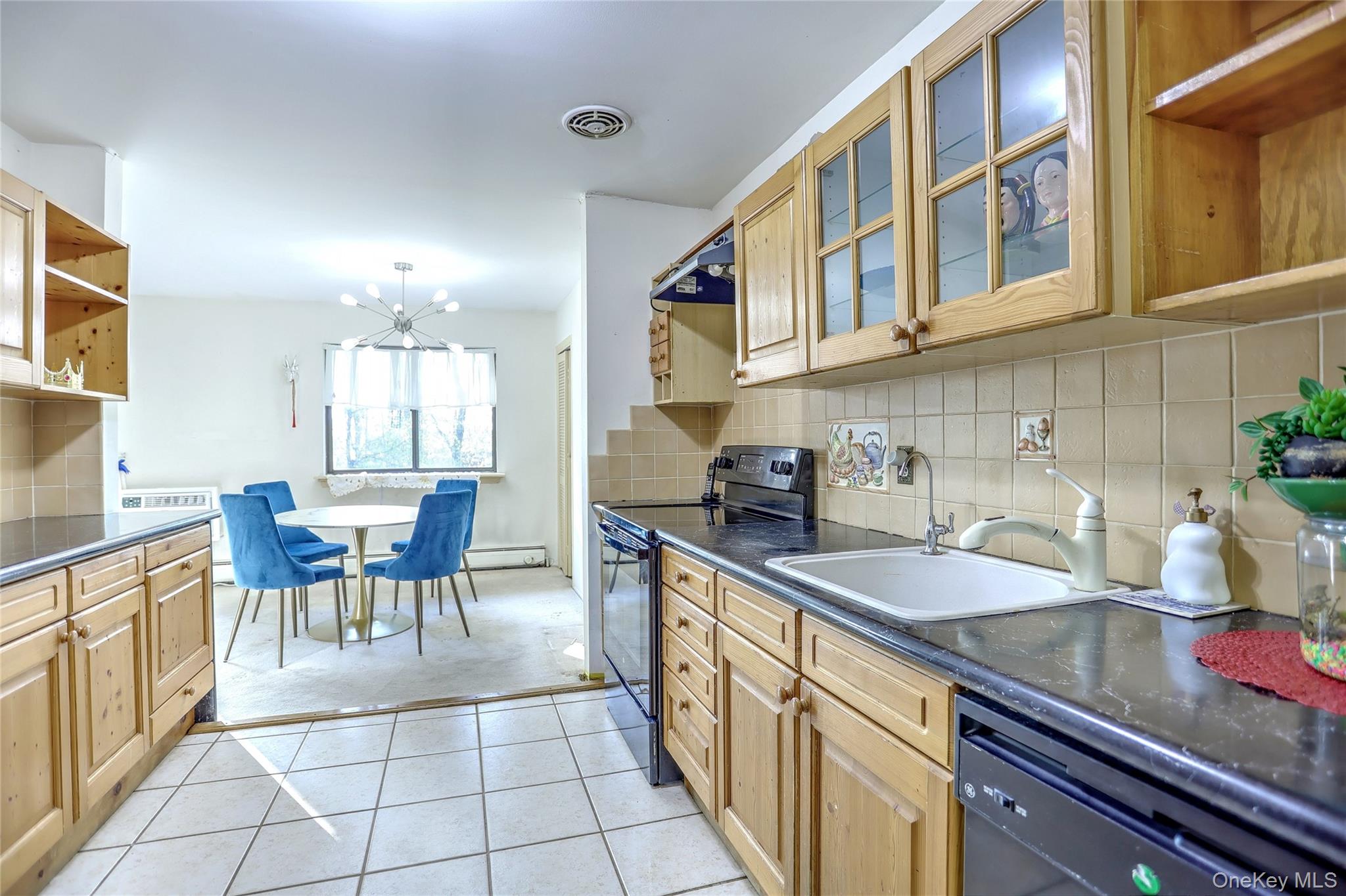 5 Secora Road, Unit F7 Spring Valley, NY 10977 - Photo 13 of 26 a kitchen with granite countertop a sink and cabinets