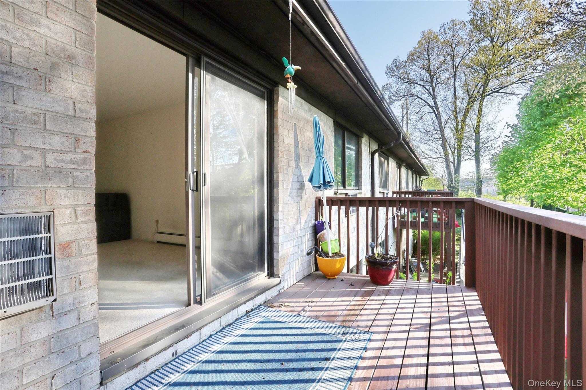 5 Secora Road, Unit F7 Spring Valley, NY 10977 - Photo 18 of 26 a view of a balcony with floor to ceiling windows and wooden floor