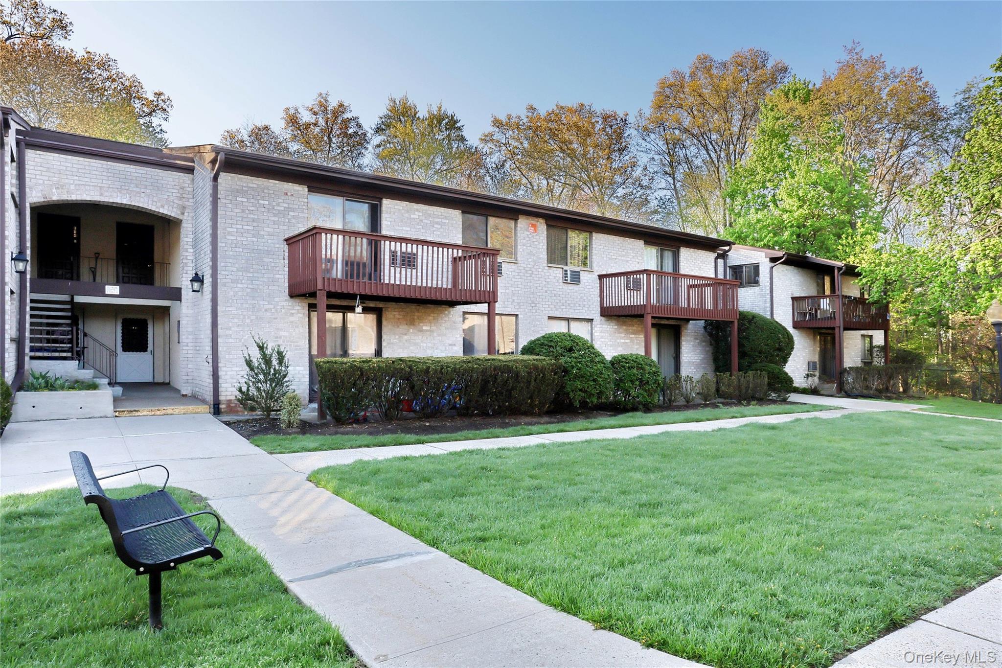 5 Secora Road, Unit F7 Spring Valley, NY 10977 - Photo 2 of 26 a view of a house with a yard and sitting area