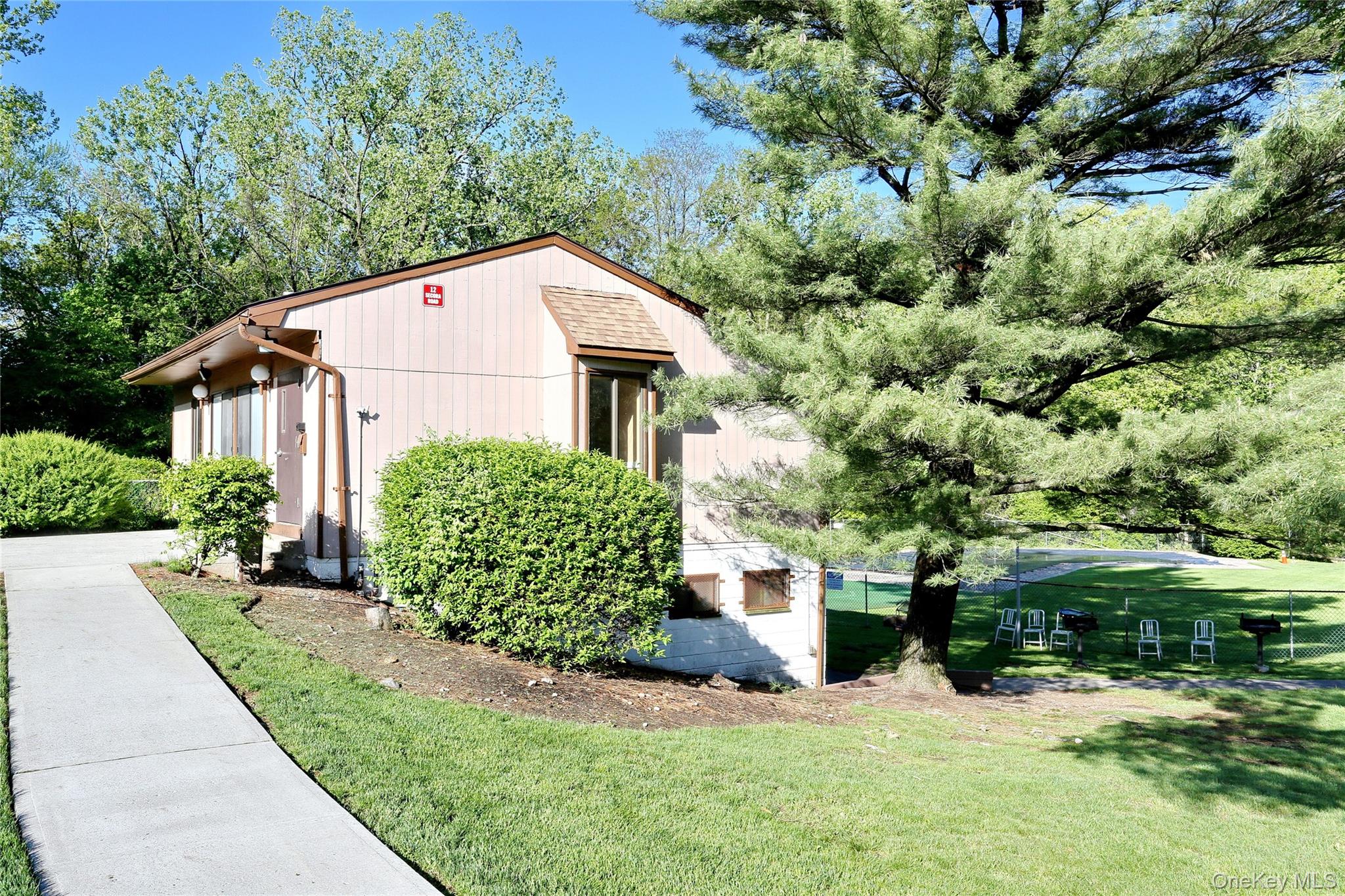 5 Secora Road, Unit F7 Spring Valley, NY 10977 - Photo 21 of 26 a view of a small house with yard and plants