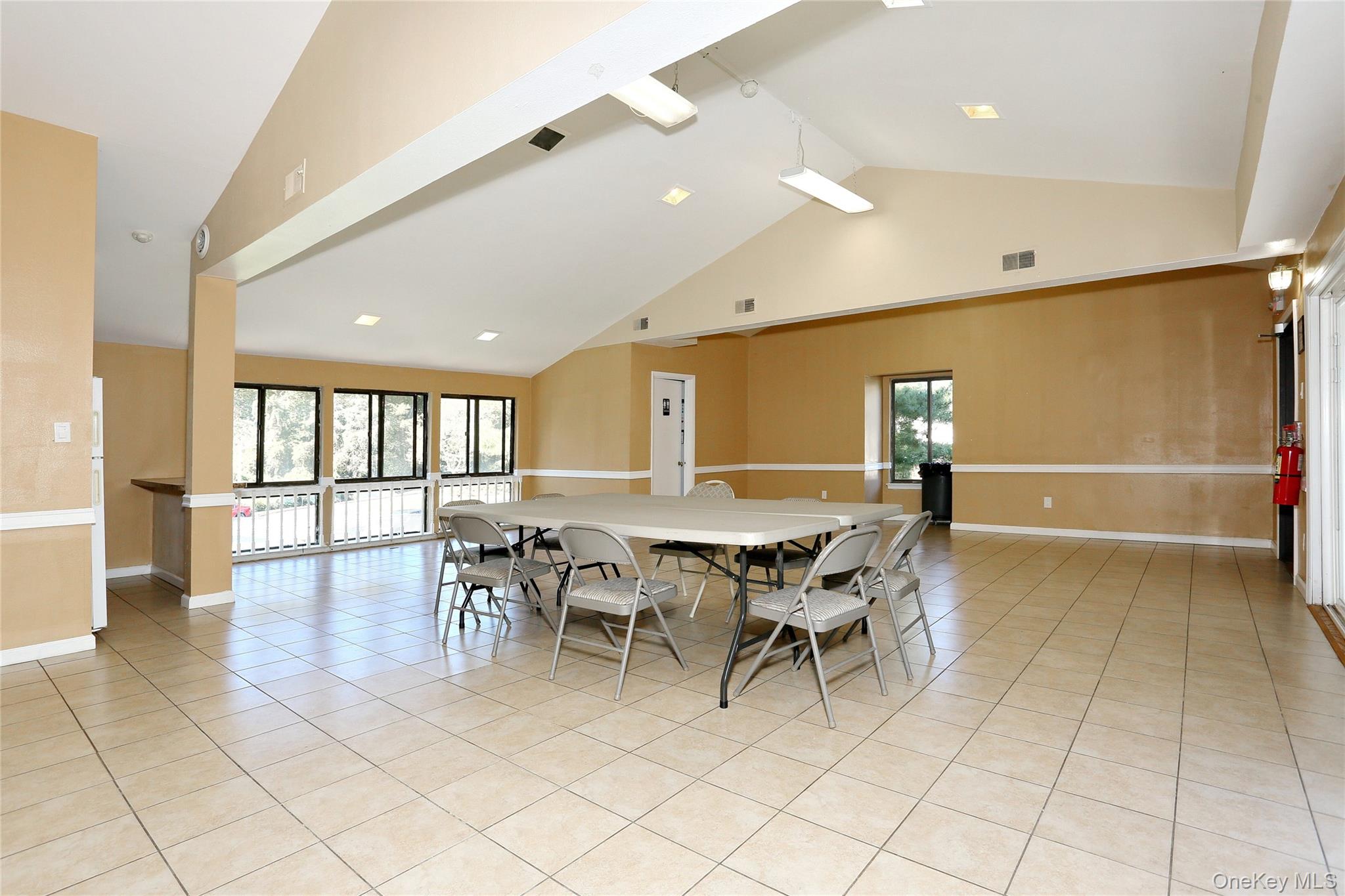 5 Secora Road, Unit F7 Spring Valley, NY 10977 - Photo 22 of 26 a dining room with furniture and wooden floor