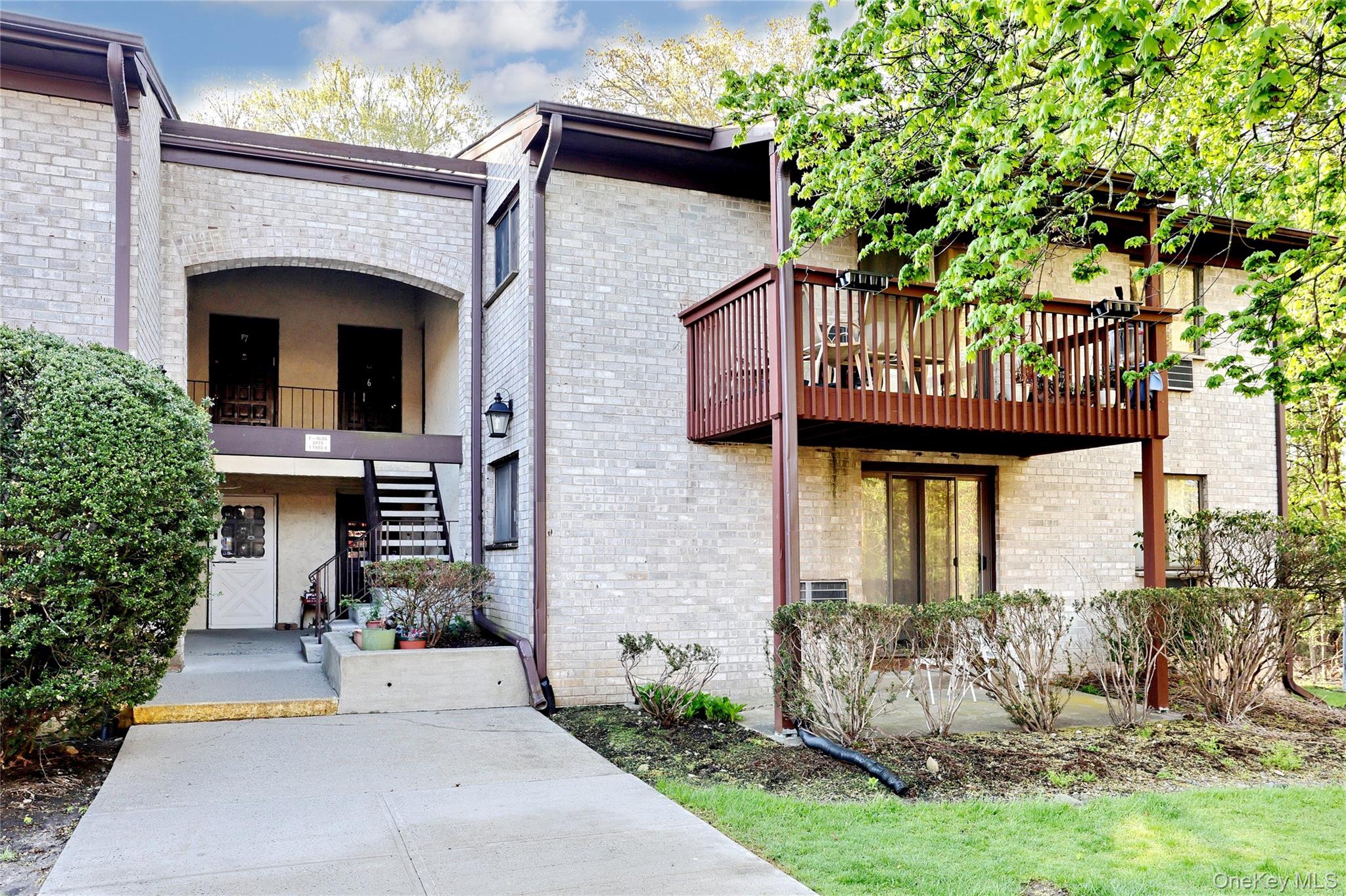 5 Secora Road, Unit F7 Spring Valley, NY 10977 - Photo 3 of 26 a front view of a house with garden
