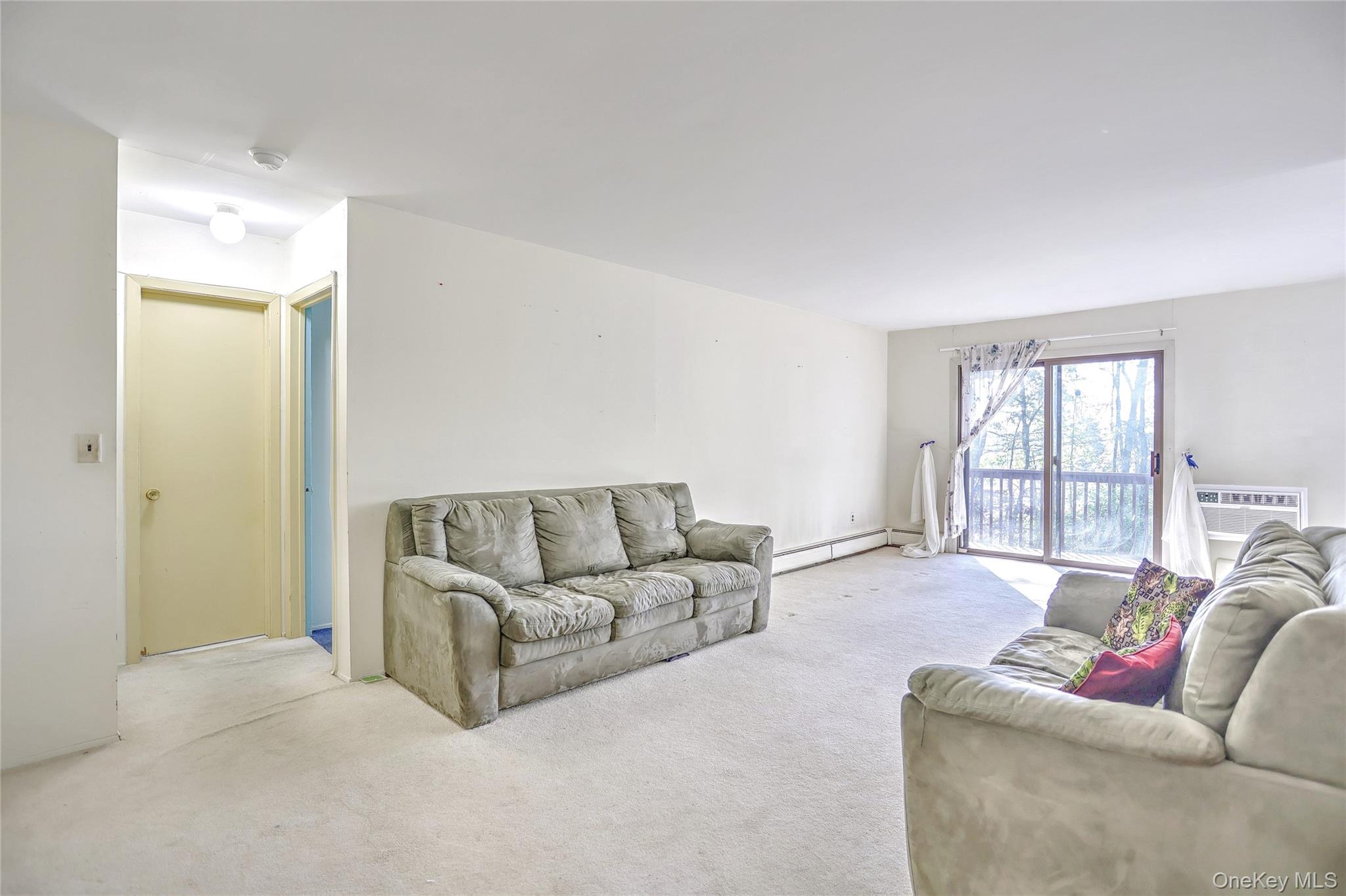 5 Secora Road, Unit F7 Spring Valley, NY 10977 - Photo 5 of 26 a living room with furniture and a large window