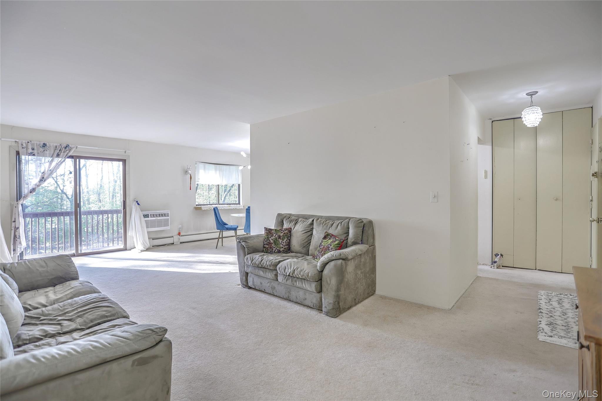 5 Secora Road, Unit F7 Spring Valley, NY 10977 - Photo 6 of 26 a living room with furniture and a large window