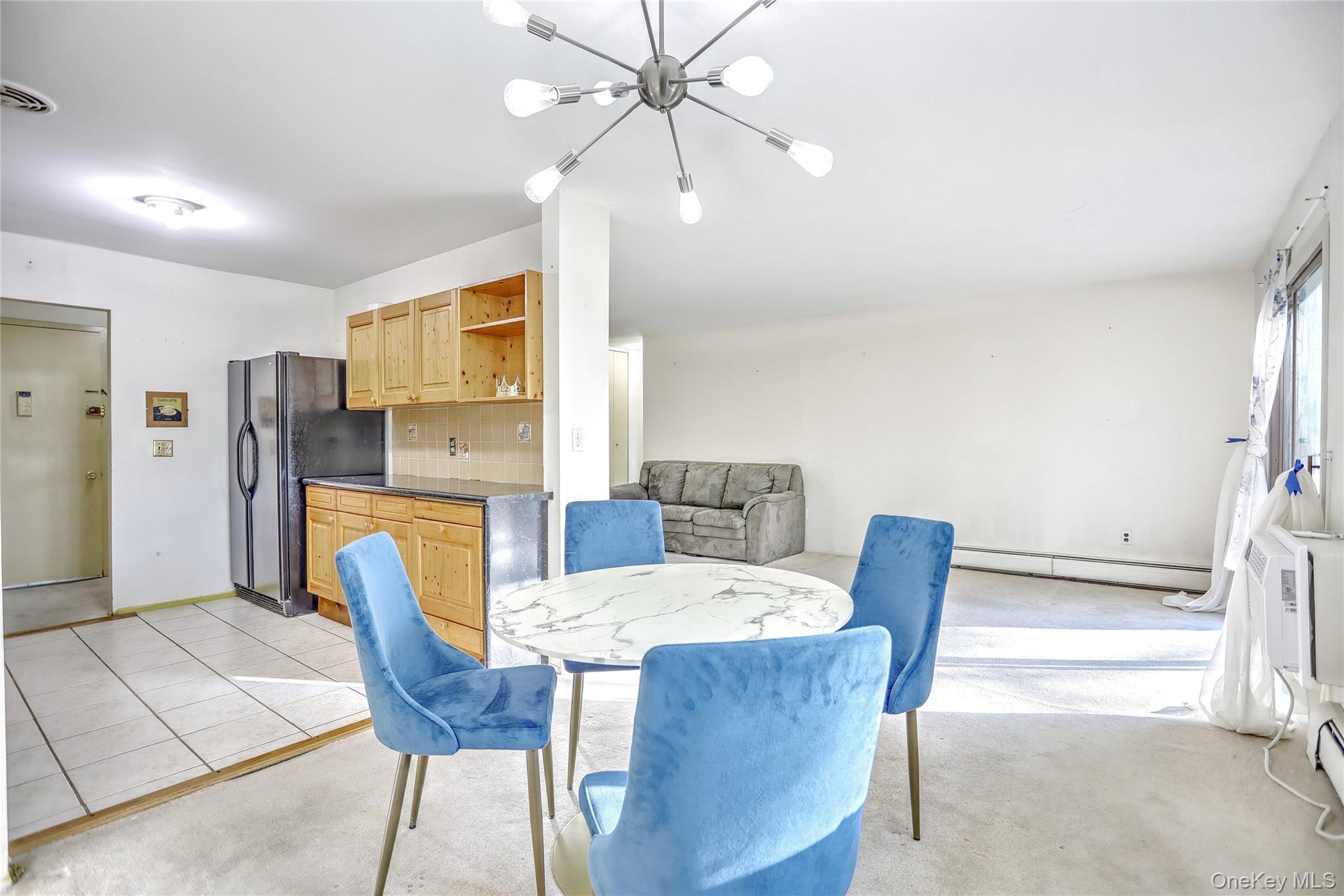 5 Secora Road, Unit F7 Spring Valley, NY 10977 - Photo 10 of 26 a view of a dining room with furniture and a chandelier