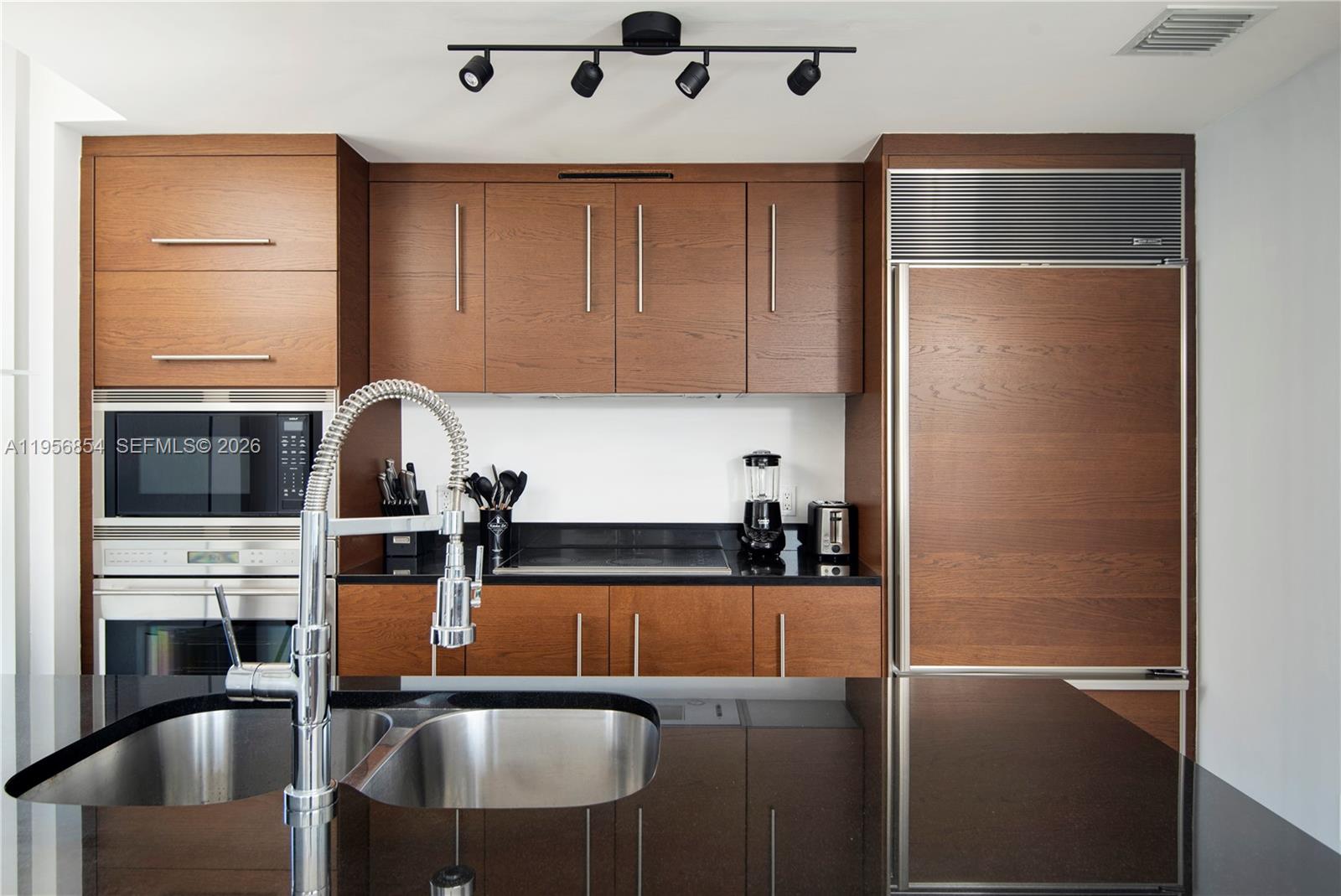 485 Brickell Avenue, Unit 3208 Miami, FL 33131 - Photo 17 of 29 a kitchen with stainless steel appliances granite countertop a refrigerator and a sink