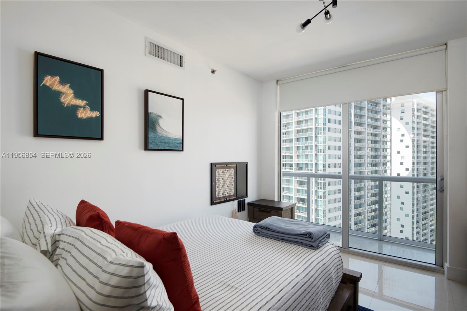 485 Brickell Avenue, Unit 3208 Miami, FL 33131 - Photo 23 of 29 a bedroom with a bed and a window