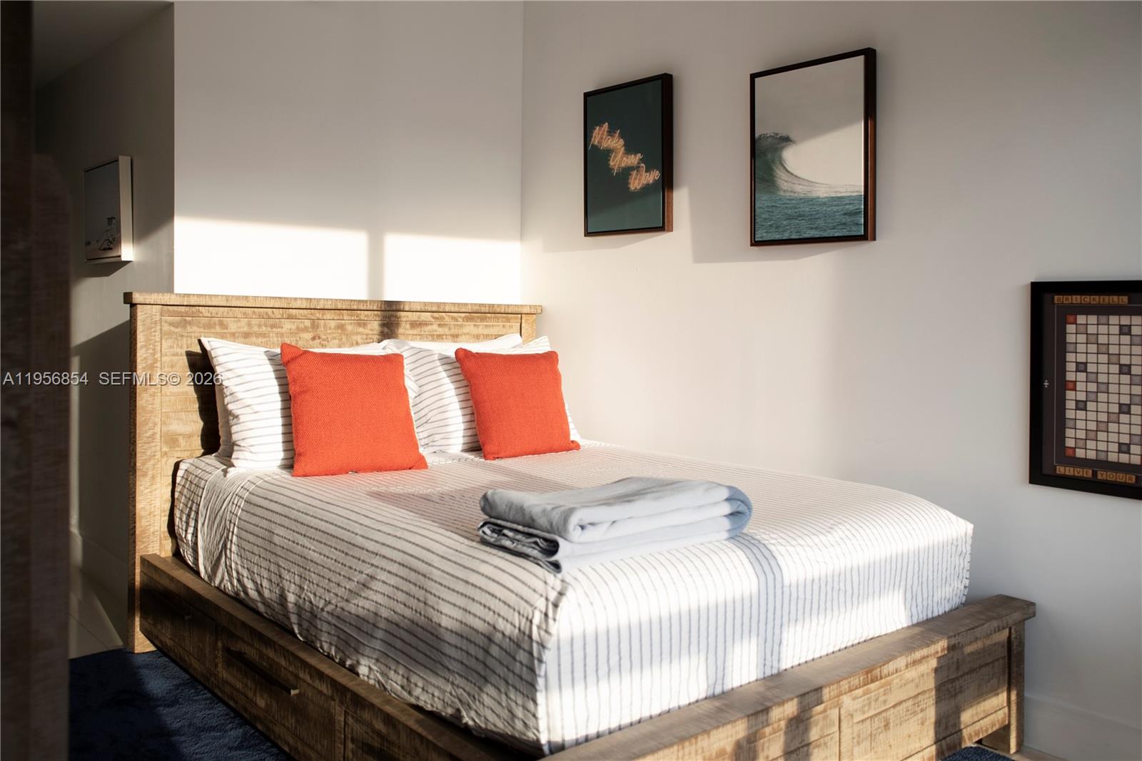 485 Brickell Avenue, Unit 3208 Miami, FL 33131 - Photo 24 of 29 a bedroom with a bed and wall painting