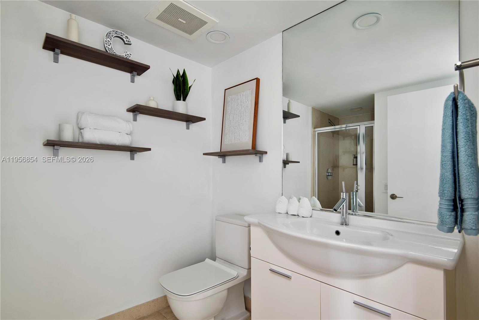 485 Brickell Avenue, Unit 3208 Miami, FL 33131 - Photo 27 of 29 a bathroom with a toilet sink and mirror