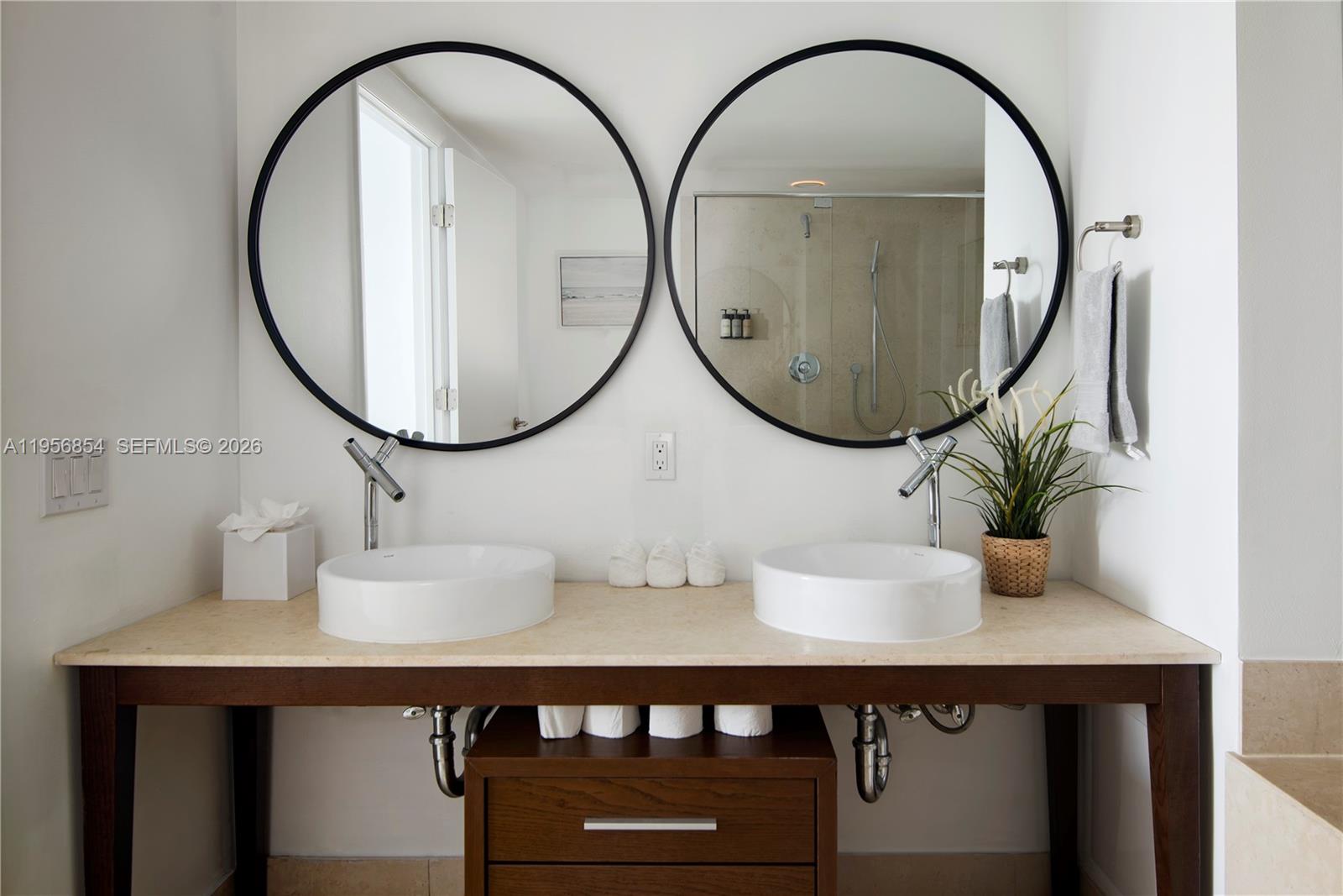485 Brickell Avenue, Unit 3208 Miami, FL 33131 - Photo 28 of 29 a bathroom with a sink and a mirror
