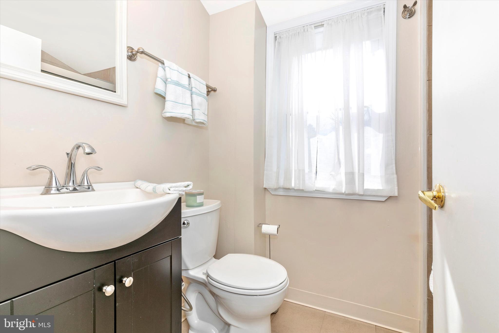 1502 Church Road Oreland, PA 19075 - Photo 17 of 39 a bathroom with a sink a toilet and a mirror