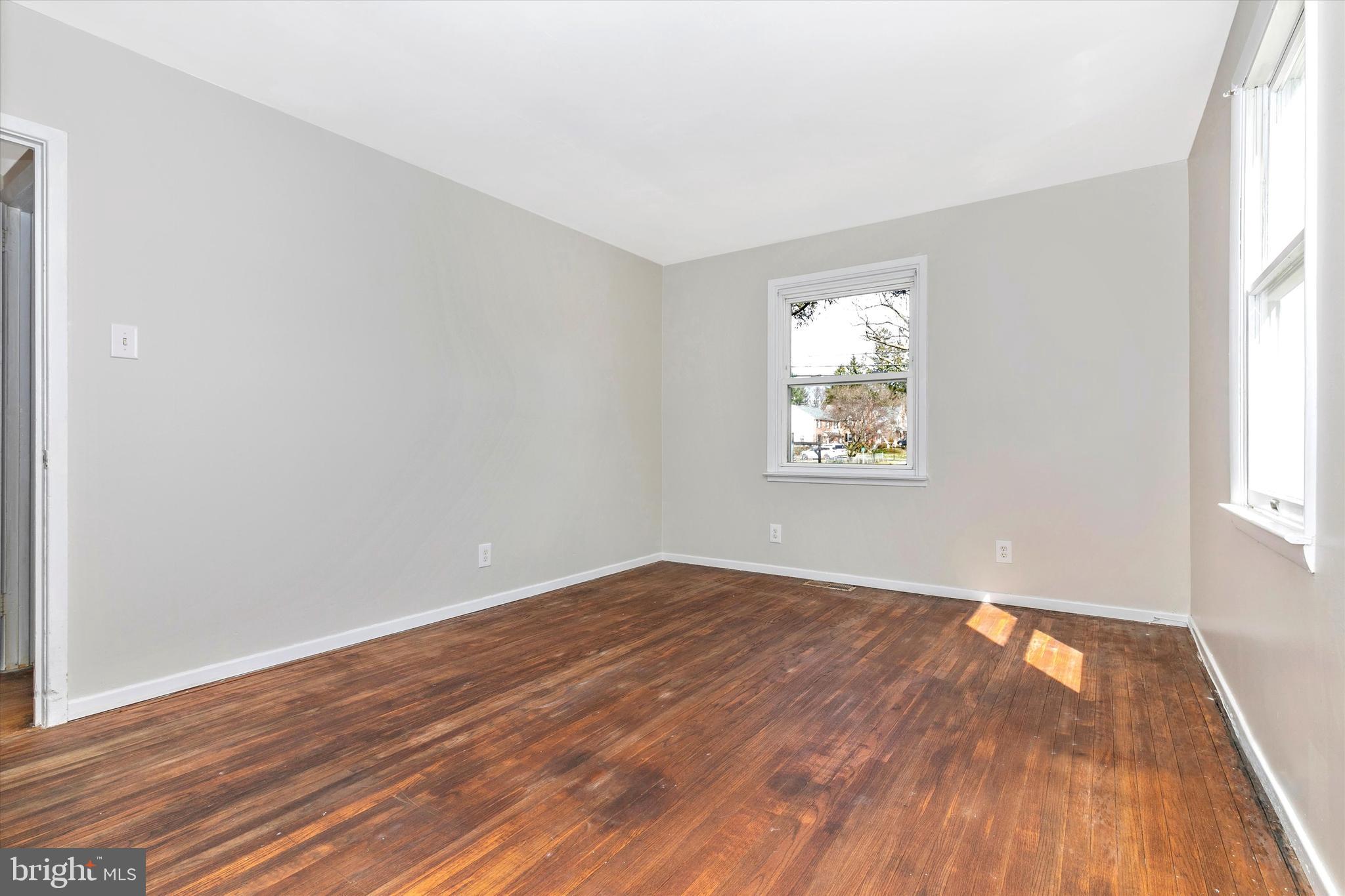 1502 Church Road Oreland, PA 19075 - Photo 26 of 39 an empty room with wooden floor and windows