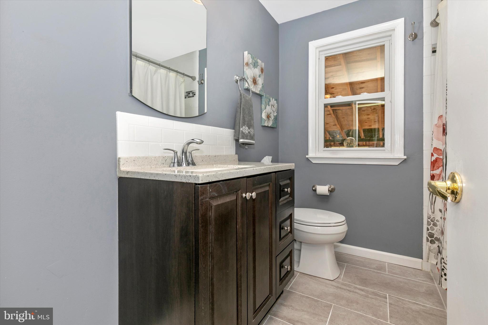 1502 Church Road Oreland, PA 19075 - Photo 28 of 39 a bathroom with a sink toilet and mirror