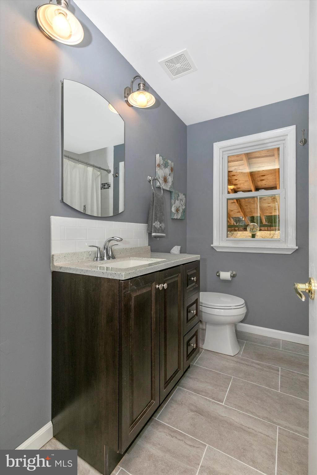 1502 Church Road Oreland, PA 19075 - Photo 29 of 39 a bathroom with a sink vanity and a toilet