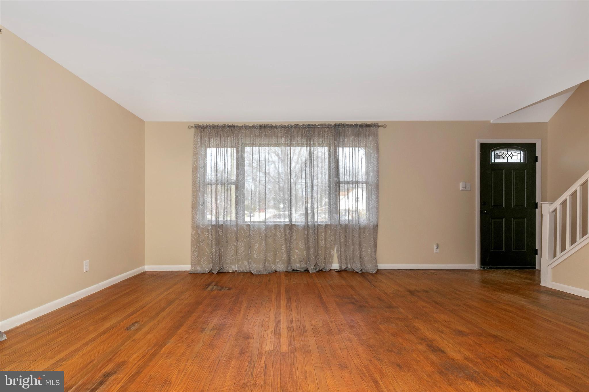 1502 Church Road Oreland, PA 19075 - Photo 4 of 39 an empty room with wooden floor and a window