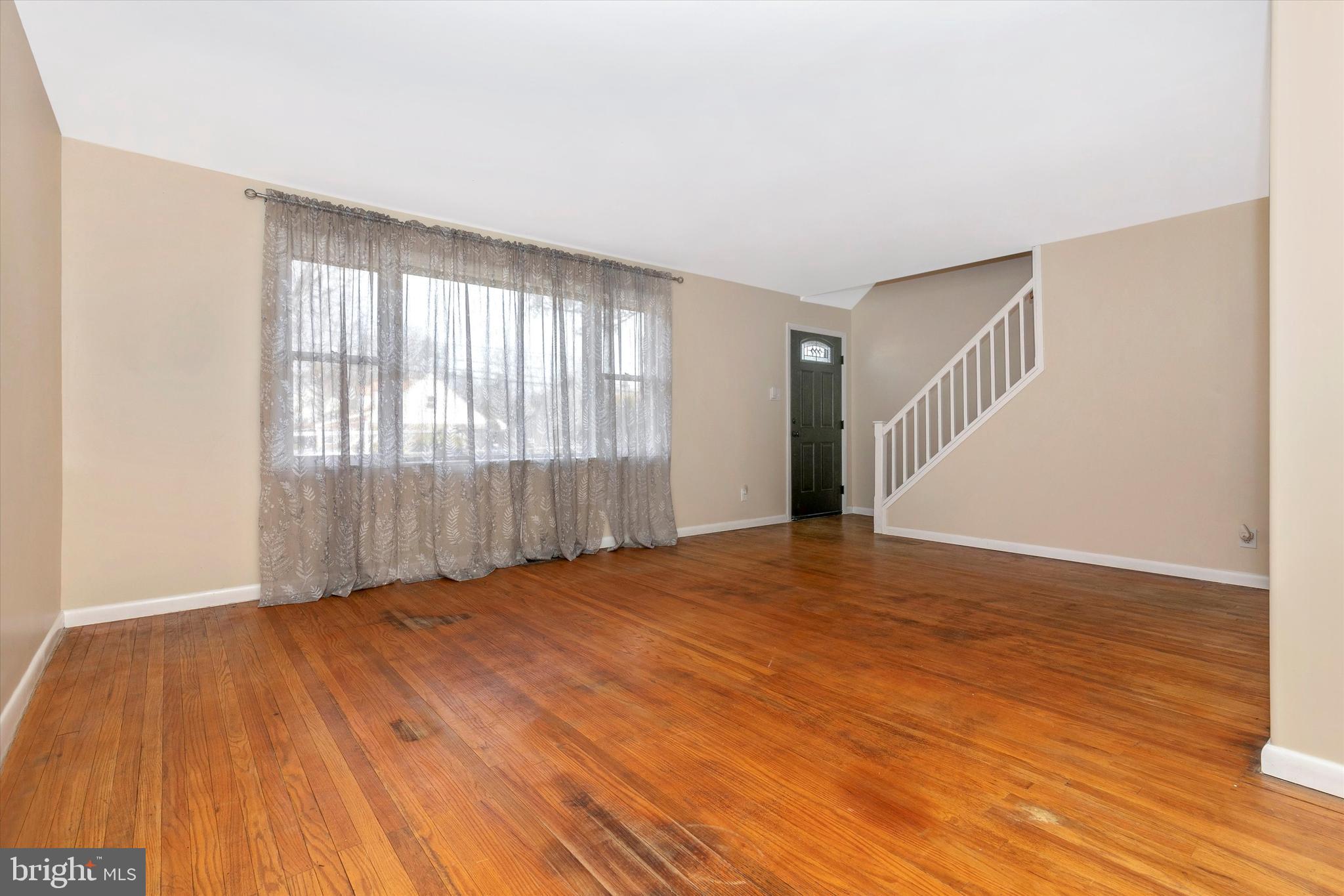 1502 Church Road Oreland, PA 19075 - Photo 6 of 39 a view of an empty room with wooden floor and a window