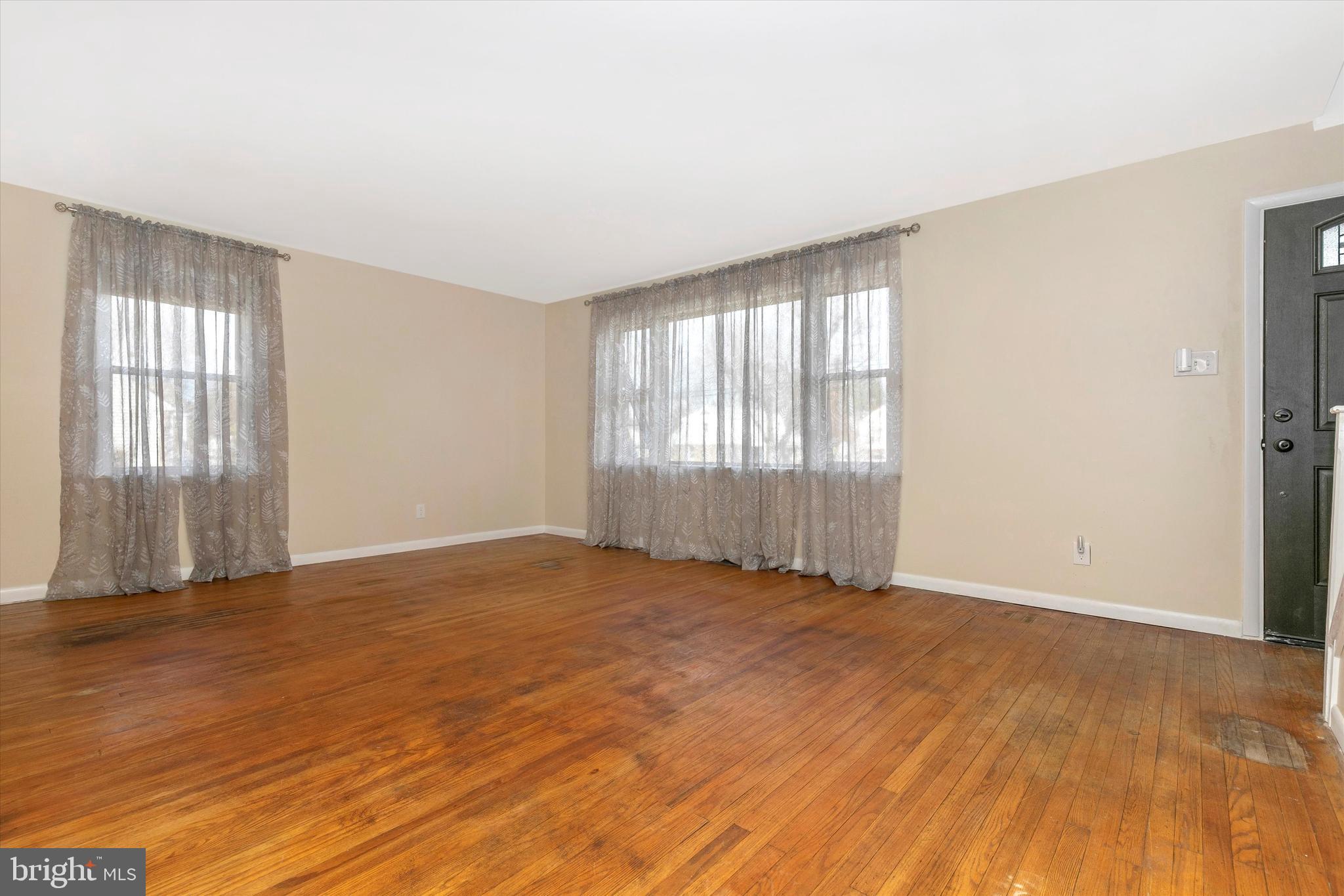 1502 Church Road Oreland, PA 19075 - Photo 7 of 39 an empty room with wooden floor and windows