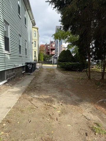 a view of a street with cars parked