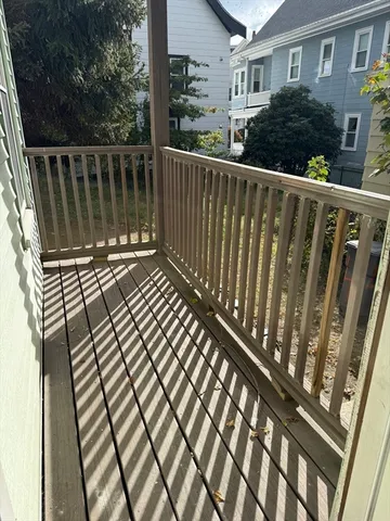 a view of a balcony with wooden floor