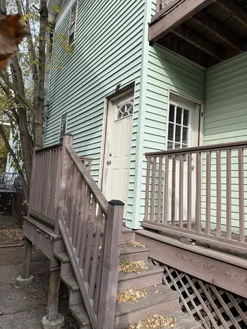 a view of a house with wooden fence