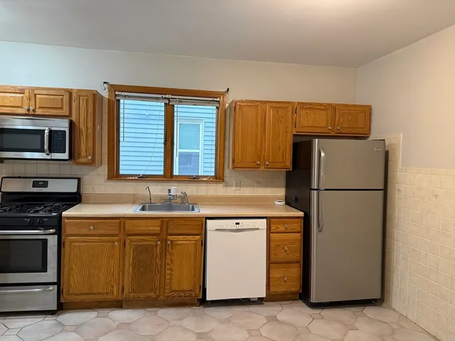 a kitchen with a sink a stove and refrigerator