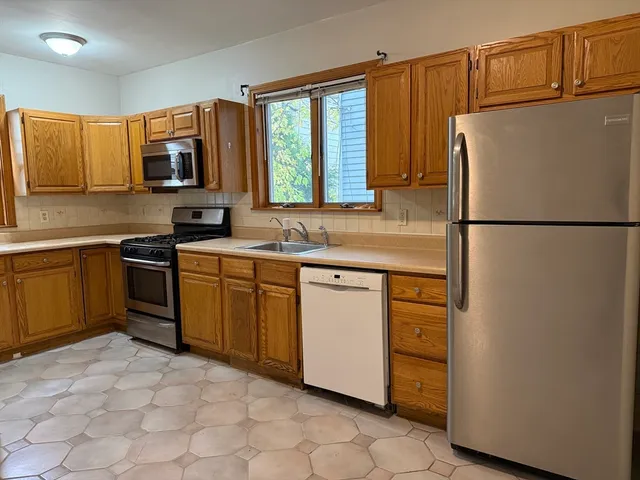 a kitchen with a refrigerator sink and stove