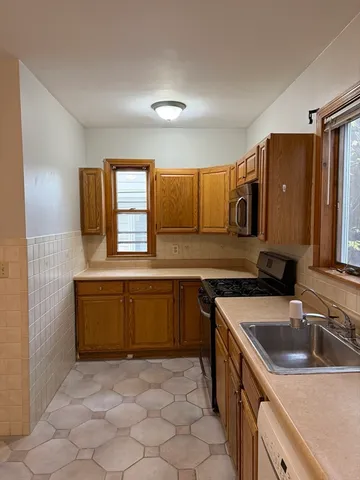 a kitchen that has a sink and a stove in it