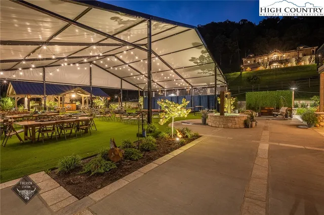 a view of a swimming pool with a patio and a garden