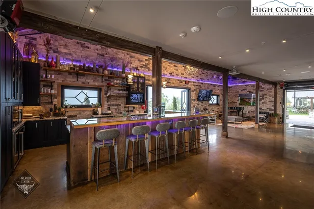 a open kitchen with stainless steel appliances granite countertop a stove top oven and cabinets