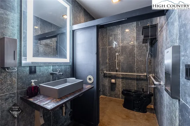 a bathroom with a sink a mirror and a shower