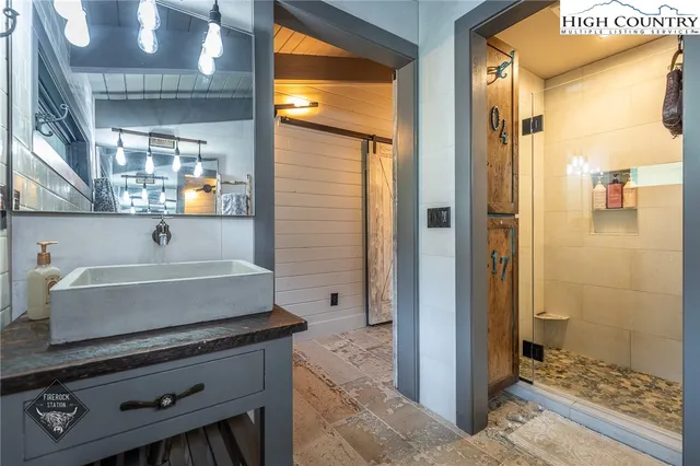 a balcony with wooden floor and outdoor seating