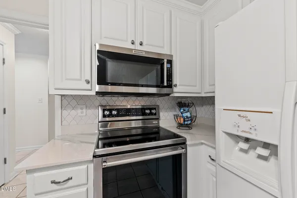 a kitchen with white cabinets and a sink