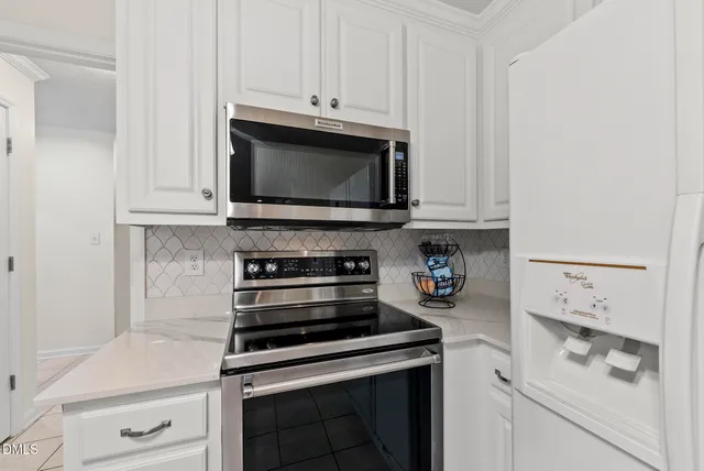 a kitchen with white cabinets and a sink