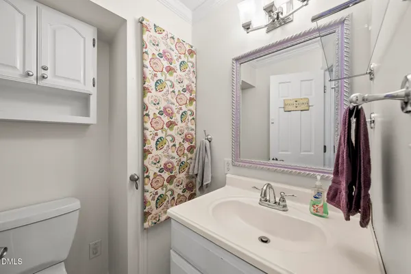 an empty room with a chandelier fan and windows