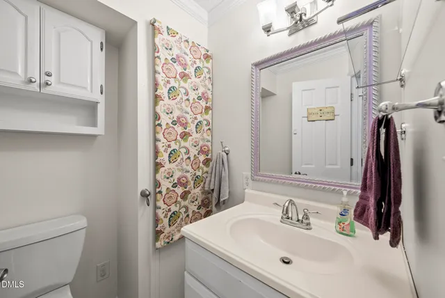 an empty room with a chandelier fan and windows