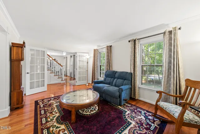 a bathroom with a toilet and a potted plant